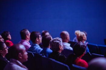 People in a lecture hall listening to a presentation